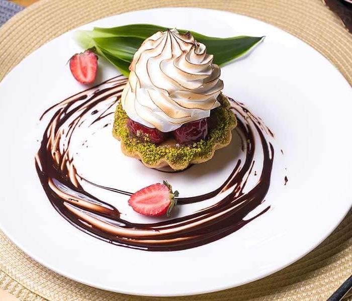 Tartlet with cherries and whipped cream