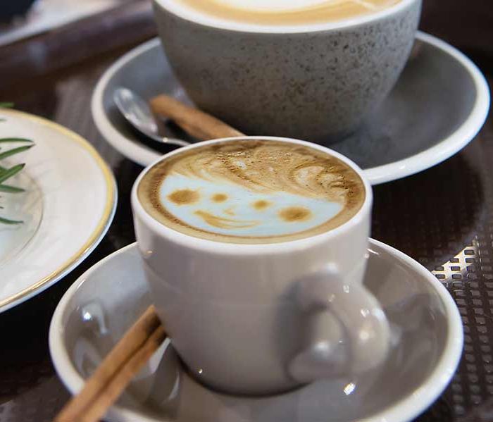 Cups of cappuccino with hot milk