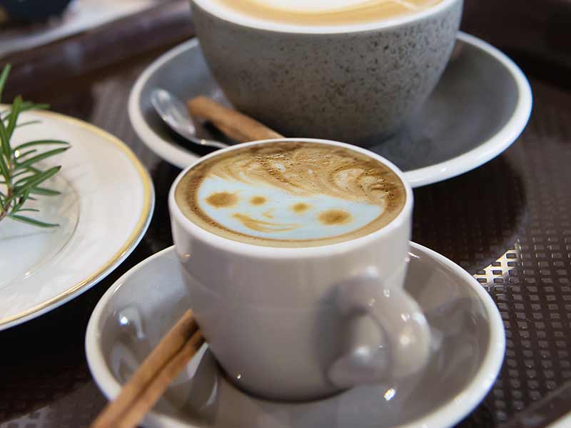 Cups of cappuccino with hot milk